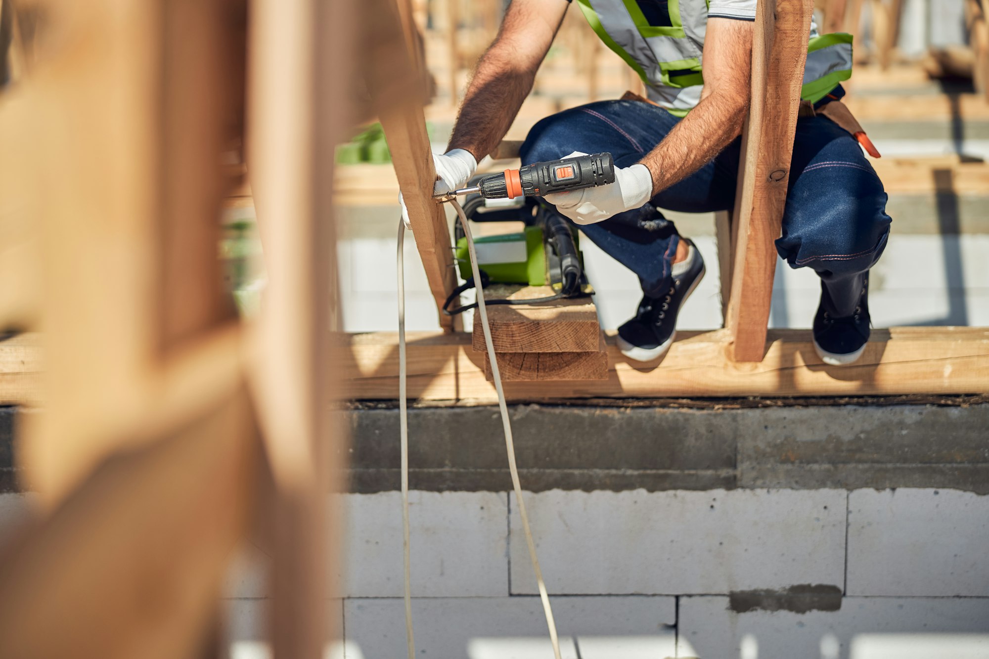 Close up of professional constructor using screwdriver