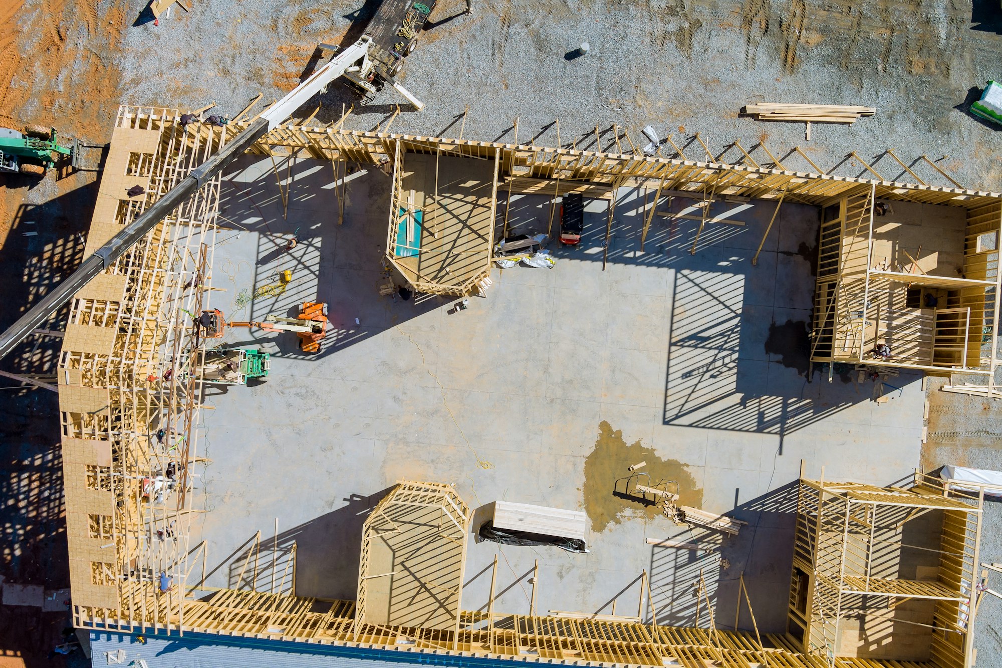 New residential construction home framing against a crane holds is new in wood roofing